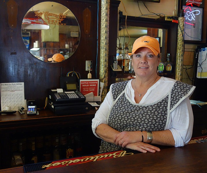 Shannon Holtzhauser, owner of Holtzhauser's Bar and Grill in Portland, stands behind the bar Friday afternoon, Sept. 2, 2016. Her grandfather, about a century earlier, purchased the bar.