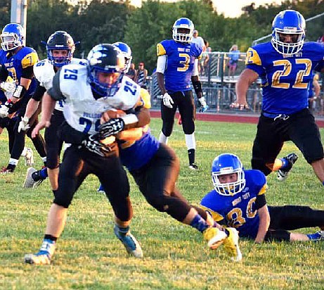 South Callaway junior running back Dalton Stone tries to fight his way out of
the grasp of a Wright City defender on his 10-yard touchdown run in the first
quarter of the Bulldogs' 46-6 rout of the Wildcats in Friday night's EMO opener
in Wright City. (Shelly Sconce/Contributed)