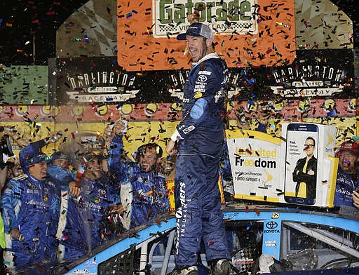 Martin Truex Jr. celebrates in Victory Lane after winning the NASCAR Sprint Cup Series auto race at Darlington Raceway on Sunday, Sept. 4, 2016, in Darlington, S.C. 