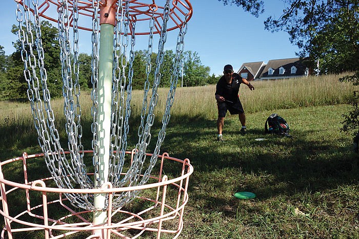 Russ Burns aims for the chains at the conclusion of the ninth annual Jefferson City Disc Golf Open on Saturday, Sept. 3, 2016 at Binder Park.