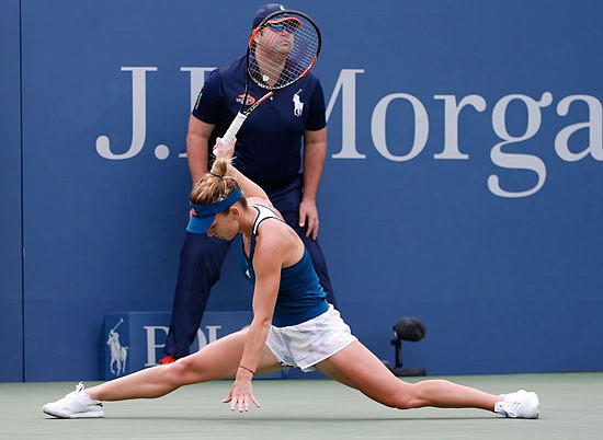 Simona Halep slams her racket after missing a shot Monday against Carla Suarez Navarro during the fourth round of the U.S. Open in New York.