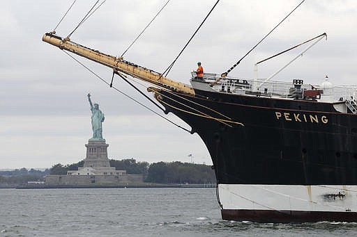 The Peking passes the Statue of Liberty en route to a dry dock on Staten Island, Wednesday, Sept. 7, 2016, in New York. 