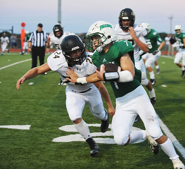 Blair Oaks running back Jake Van Ronzelen runs to the outside of Versailles defensive back Taylor Dobbins before being brought down out of bounds during last Friday night's game at the Falcon Athletic Complex in Wardsville.