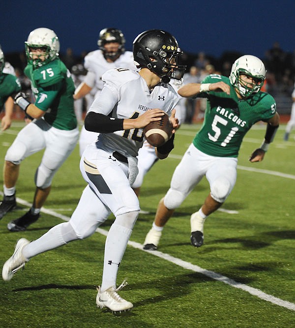 Versailles quarterback David Connor races across the field as he looks for an open receiver against Blair Oaks last Friday night at Wardsville.