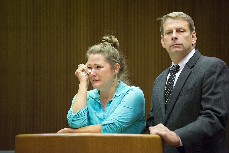 Kimberly Mitchell wipes away tears Friday, Sept. 9, 2016 as Judge Bobby Lockhart discusses the gravity of her actions before sentencing Mitchell to 25 years for sexual assault of a child.