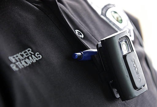 In this file photo taken on Tuesday, Sept. 29, 2015, a body camera is attached to the uniform of Whitestown Police Department officer Reggie Thomas during a traffic stop, in Whitestown, Ind. 