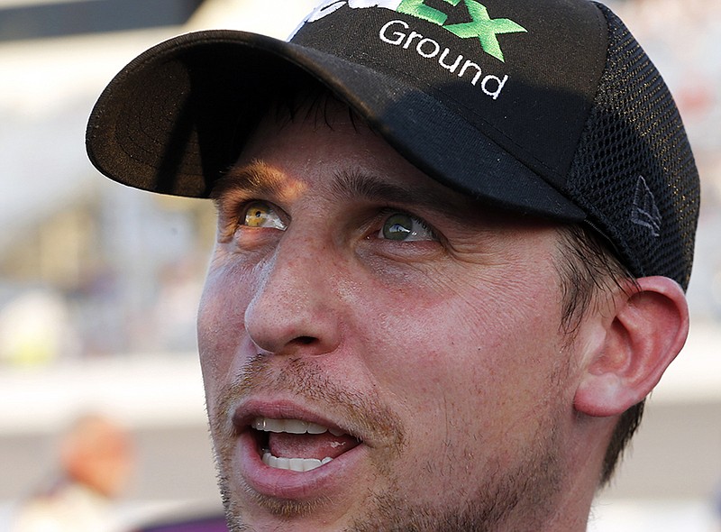 Denny Hamlin smiles as he talks to the media after winning the pole for Saturday's NASCAR Sprint Cup auto race on Friday at Richmond International Raceway in Richmond, Va.