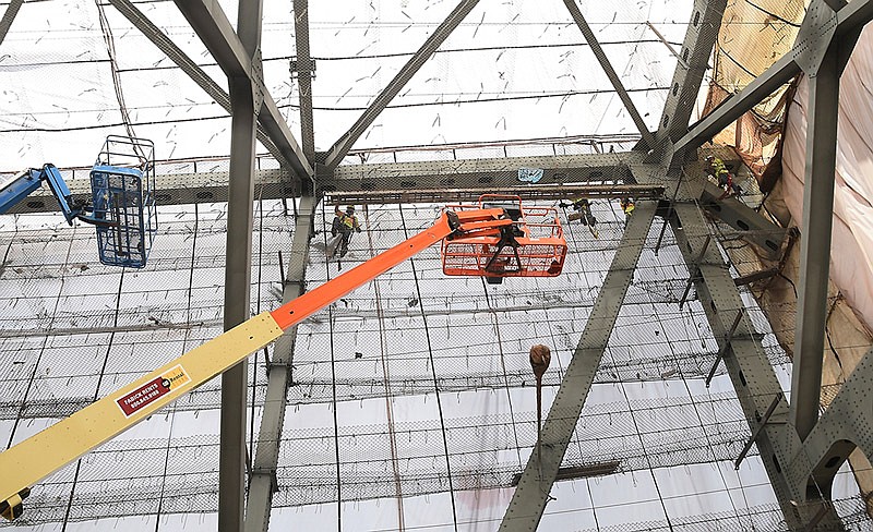 In this June 29, 2016 file photo, crews walk on secured chainlink fence as they work on upper support beams of the westbound Missouri River bridge in Jefferson City. 