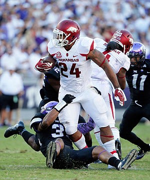 Arkansas running back Kody Walker fights to get extra yardage as TCU linebacker Sammy Douglas tries to make the stop during last Saturday's game in Fort Worth, Texas. Walker, a former Jefferson City Jay, had 19 yards rushing in the contest.