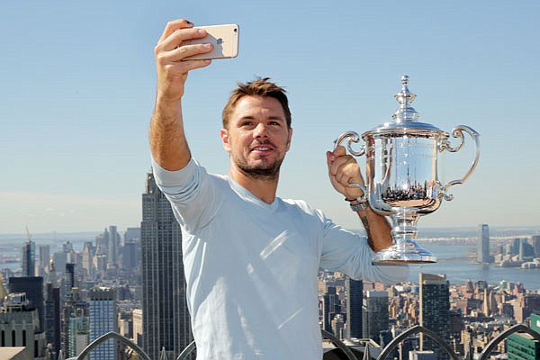 With the New York skyline as the background, U.S. Open men's singles tennis champion Stan Wawrinka takes a selfie Monday atop Rockefeller Center.