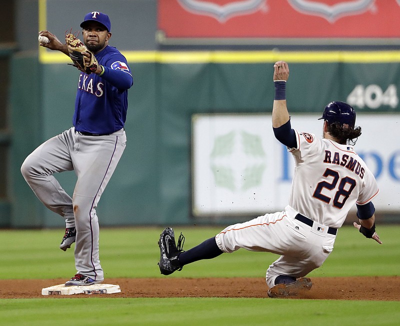 Texas Rangers shortstop Elvis Andrus, left, steps on second base as he turns a double play as Houston Astros' Colby Rasmus (28) slides into second during the fifth inning of a baseball game Tuesday, Sept. 13, 2016, in Houston. Rasmus was out at second and Marwin Gonzalez was out at first on the double play.