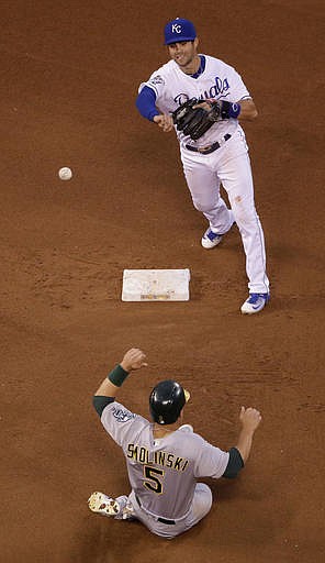 Kansas City Royals second baseman Whit Merrifield throws to first for the double play hit into by Oakland Athletics' Marcus Semien, after forcing Jake Smolinski (5) out at second during the fourth inning of a baseball game Tuesday, Sept. 13, 2016, in Kansas City, Mo. 