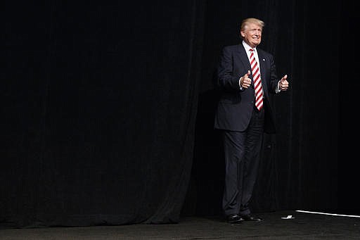 Republican presidential candidate Donald Trump arrives to speak at a campaign rally, Tuesday, Sept. 13, 2016, in Clive, Iowa.