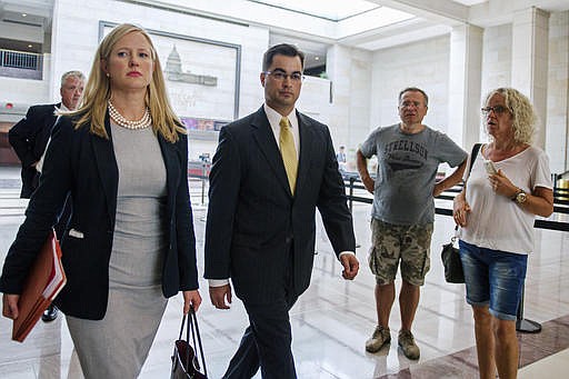 In this Sept. 10, 2015 file photo, Bryan Pagliano, center, a former State Department employee who helped set up and maintain a private email server used by Hillary Rodham Clinton, departs Capitol Hill in Washington. House Republicans on Tuesday, Sept. 13, 2016, continue their attacks on former Secretary of State Clinton's emails by calling the tech expert who set up her private server and representatives from the company that maintained the system to testify at a congressional hearing. Pagliano, a former information resource management adviser at the State Department, is scheduled to appear Tuesday before the Oversight and Government Reform Committee. 