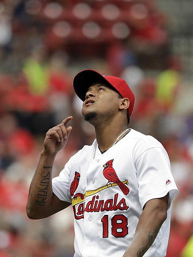 St. Louis Cardinals starting pitcher Carlos Martinez looks skyward as he walks off the field after working during second inning of a baseball game against the Chicago Cubs Wednesday, Sept. 14, 2016, in St. Louis. 