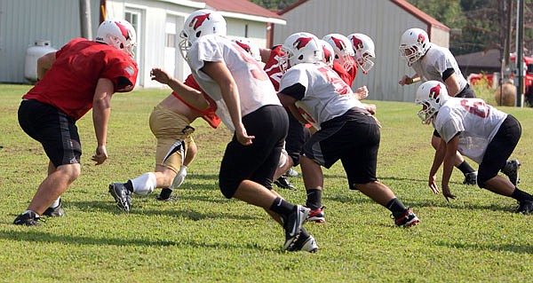 Tipton linemen work on their blocking schemes during a practice this week at the school. Tiption will host Liberal on Saturday.