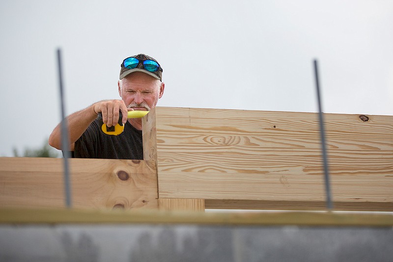 Mike Pollock with Pollock Construction of Colorado checks the measurement on the top of a doorway threshold at the new Arkansas Welcome Center being built on U.S. Highway 71 north of Texarkana. Work started on the $2.5 million project in January. The general contractor on the project is Contech Contractors Inc. of Texarkana. The new facility will offer the similar amenities as the rest area at mile maker 7 on Interstate 30. 