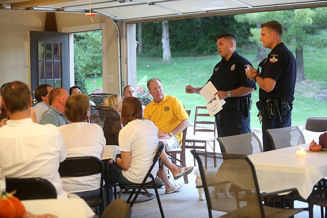 Officers Paul Gash, left, and Todd Bickel speak Thursday, Sept. 15, 2016 during National Night Out, where neighborhood residents and police officers gathered to discuss crime prevention.