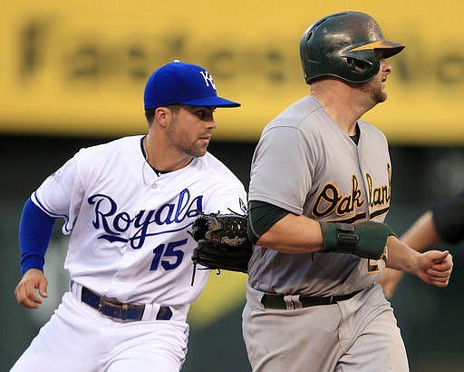 Kansas City Royals second baseman Whit Merrifield (15) tags out Oakland Athletics' Stephen Vogt during the third inning of a baseball game at Kauffman Stadium in Kansas City, Mo., Thursday, Sept. 15, 2016.