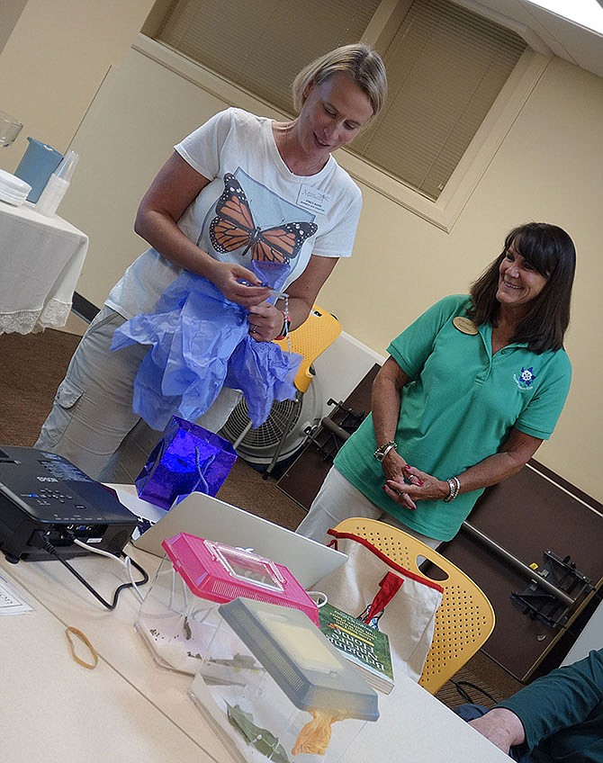 Stacey Barr, Boones Lick master naturalist and Missourians for Monarchs team leader, spoke Tuesday evening about monarch butterflies to members of the Fulton Garden Club. Diane Neterer, president of the garden club, left, gave her a gift after the presentation.