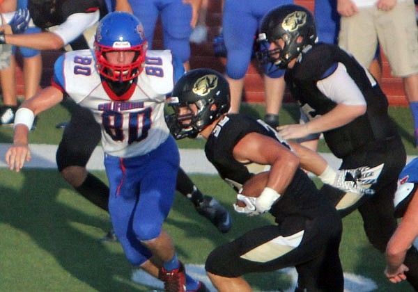 Versailles running back Shane Randall (center) rushes for a gain during last Friday night's game against California.