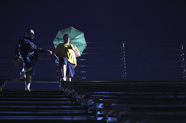 Terry Jackson and his brother Shannon Jackson stand and wait for So Long Summer Music Fest's set list Friday to begin at Jefferson Jaycee Fairgrounds. The concert was delayed because of the rain that occurred Friday afternoon and evening. The concert was the start of a weekend coordinated by Operation Bugle Boy in honor of veterans and first responders.