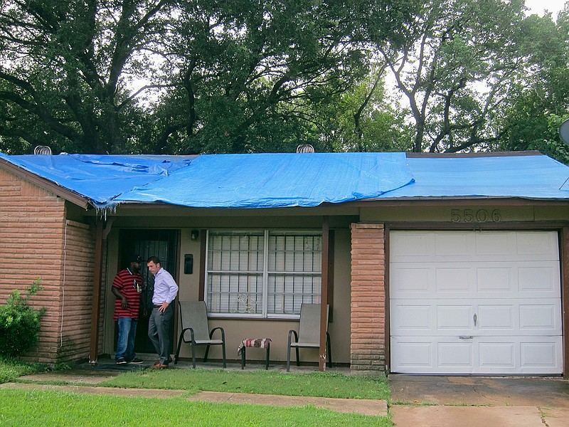 Tom McCasland, right, interim director of Houston's Housing and Community Development Department, and Nathan Washington, a senior inspector with the department, knock on the door of a Houston home, Friday, Sept. 16, 2016, as part of their efforts to speak with residents whose homes are covered by blue tarps after being damaged by Hurricane Ike or by other storms. McCasland and other department employees have been knocking on doors in various Houston neighborhoods to promote the new "Blue Tarp Program," which is looking to address long overdue repairs on many of these homes.