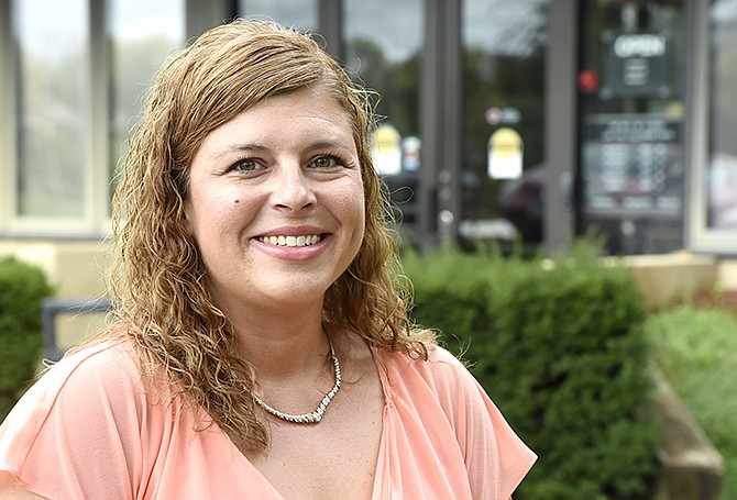 Adult brain injury coordinator Shalon Schonhardt stands in front of the Cole County Health Department. Her program covers 15 counties and provides assistance to people with brain injuries.