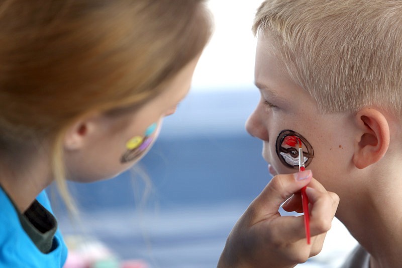 Nate Thurman, 9, gets a pokeball painted on his face during Unilever's 50th anniversary party Saturday, Sept. 17, 2016 in Jefferson City.