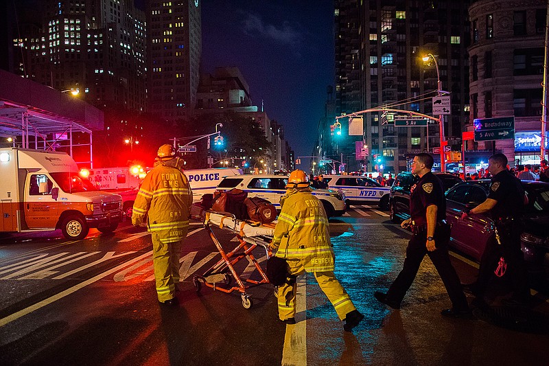 Police and firefighters work near the scene of an apparent explosion in Manhattan's Chelsea neighborhood, in New York, Saturday, Sept. 17, 2016. A law enforcement official tells The Associated Press that an explosion in the Chelsea neighborhood appears to have come from a construction toolbox in front of a building. The official spoke on condition of anonymity because the person wasn't authorized to speak about an ongoing investigation. More than two dozen people have sustained minor injuries in the explosion on West 23rd Street.