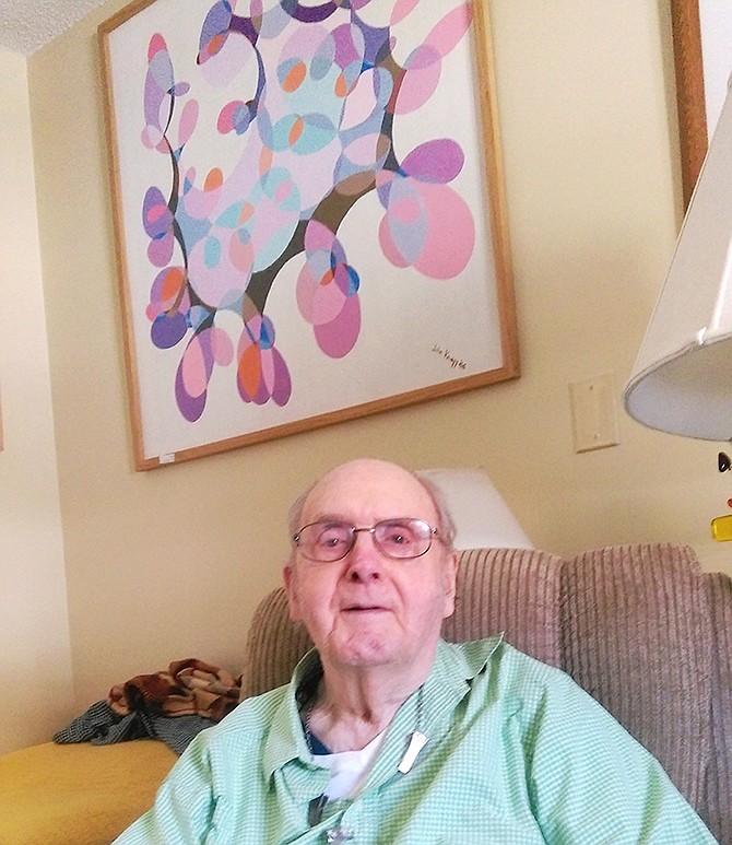 World War II veteran E. John Knapp is pictured with one of the many paintings he has completed over the years. The former navigator has also penned the story of this wartime service at the urging of his children.