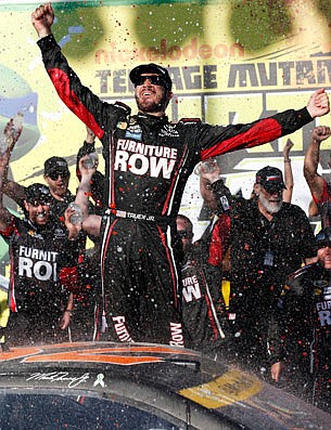 Martin Truex Jr., celebrates with his crew Sunday in Victory Lane after his win at Chicagoland Speedway in Joliet, Ill.