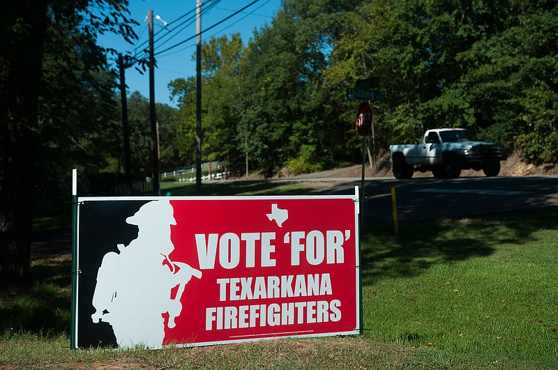 Firefighters working to convince Texarkana, Texas, voters to grant them collective bargaining rights on Election Day are distributing yard signs, such as this one seen Sunday near Summerhill Road.