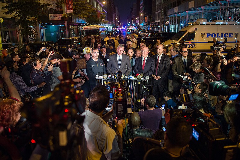 Mayor Bill de Blasio, center, and NYPD Chief of Department James O'Neill, center right, speak during a press conference near the scene of an apparent explosion on West 23rd street in Manhattan's Chelsea neighborhood, in New York, Saturday, Sept. 17, 2016. Police say more than two dozen people were injured in the explosion Saturday night.