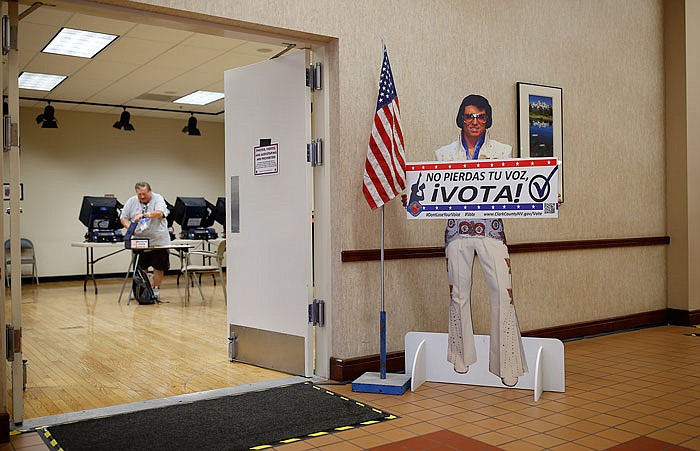 A sign with an Elvis impersonator reminds people to vote at a May early primary election polling site in Las Vegas.