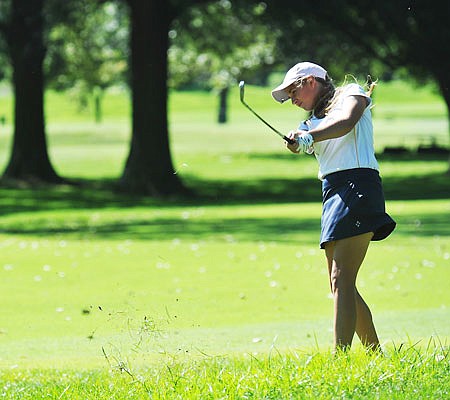 Alex Nelson of the Helias Lady Crusaders follows through on a shot Monday in the Lady Jays Capital City Invitational at Meadow Lake Acres Country Club..