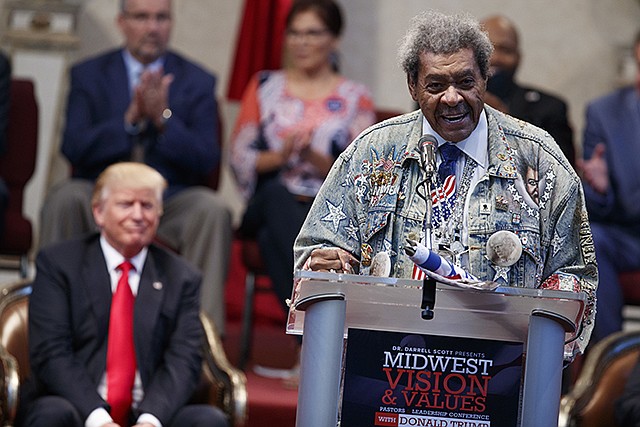 Republican presidential candidate Donald Trump listens Wednesday as he is introduced by boxing promoter Don King prior to speaking to the Pastors Leadership Conference at New Spirit Revival Center in Cleveland, Ohio.