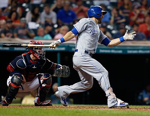 Alex Gordon of the Royals hits a RBI single as Indians catcher Roberto Perez looks on during the fifth inning of Tuesday night's game in Cleveland.