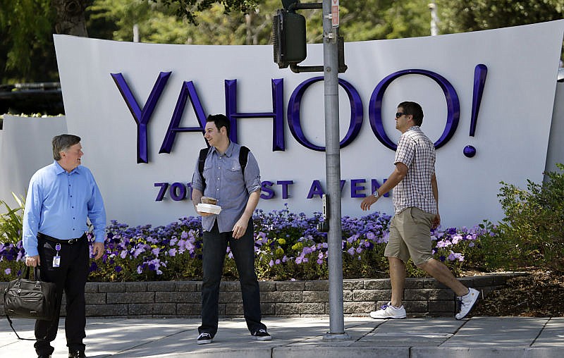 In this June 5, 2014, file photo, people walk in front of a Yahoo sign at the company's headquarters in Sunnyvale, Calif. Yahoo says the personal information of 500 million accounts have been stolen in a massive security breakdown that represents the latest setback for the beleaguered internet company. The breach disclosed on Thursday, Sept. 22, 2016, dates back to late 2014. Yahoo is blaming the hack on a "state-sponsored actor."