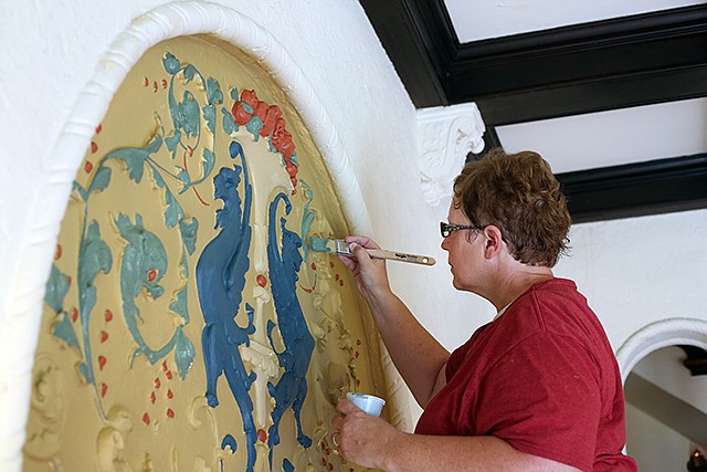 Doris Davis paints Tuesday at the Bella Vista Apartments in downtown Jefferson City. Davis is the owner of Davis Creative Painting and will be re-painting embossed designs throughout the entire apartment building.