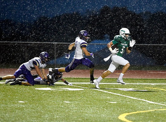 Blair Oaks running back Cody Alexander (right) races past the Hallsville defense for a touchdown during last Friday's game at the Falcon Athletic Complex.