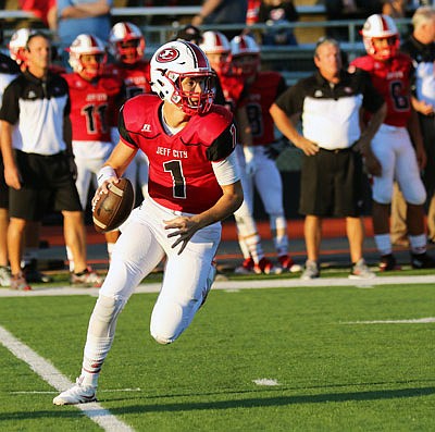 Jefferson City quarterback Gunnar See searches for a receiver to throw to during a Week 3 game against Hickman at Adkins Stadium.