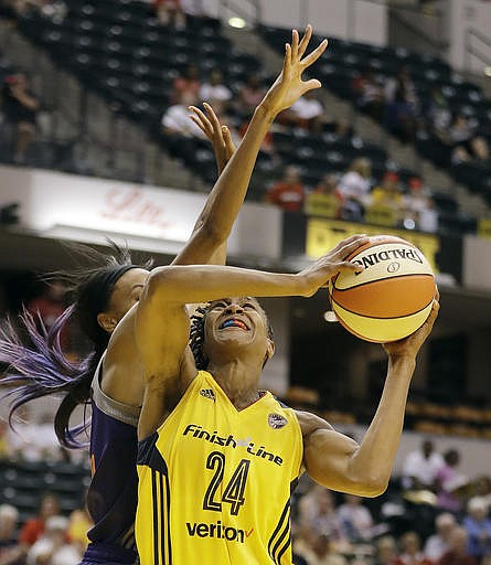 Indiana Fever's Tamika Catchings (24) is fouled by Phoenix Mercury's DeWanna Bonner (24) as she goes up for a shot during the first half of a first round WNBA playoff basketball game, Wednesday, Sept. 21, 2016, in Indianapolis. 