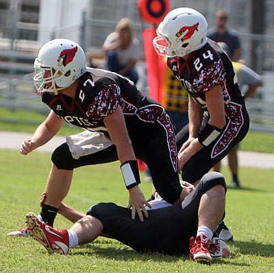 Tate Combs of Tipton steps across a Liberal player before making a tackle in the Cardinals' 32-12 win last Saturday.