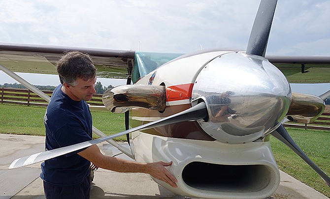Van Pray, owner of Flying V Ranch, examines the plane used for skydiving. Pray also builds modifications to his airplanes, all of which are FAA approved.