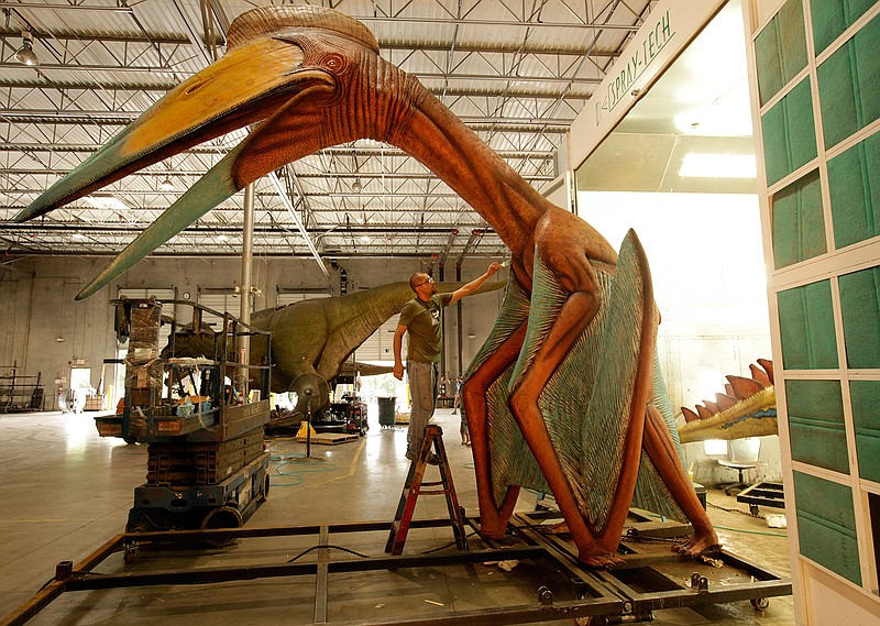 Antolin Pineda paints an animatronic dinosaur at Billings Productions in Allen, Texas, on Aug. 29, 2016. 