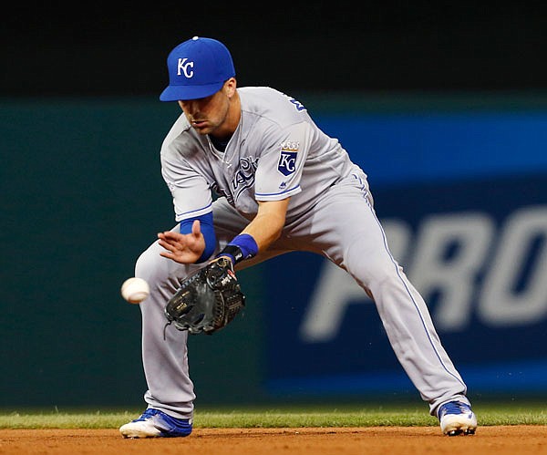 Royals second baseman Whit Merrifield fields the ball and throws out the Mike Napoli of the Indians at first base during the eighth inning of Thursday night's game in Cleveland.