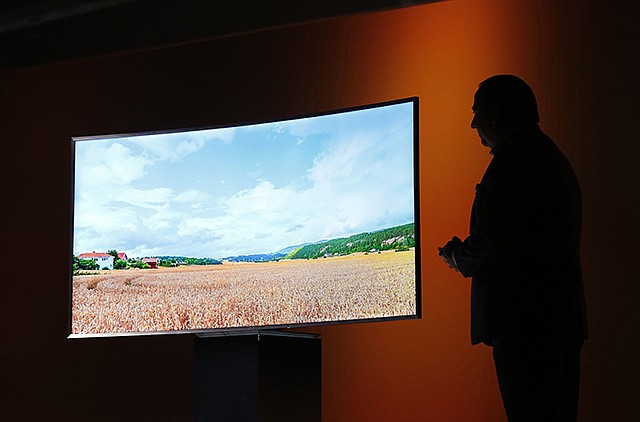 Joe Stinziano, executive vice president of Samsung Electronics America, introduces a Samsung SUHD 4K TV at a news conference in January 2015 in Las Vegas. An environmental group is accusing a trio of major TV makers of engineering their sets to make them look more energy efficient than they actually are.