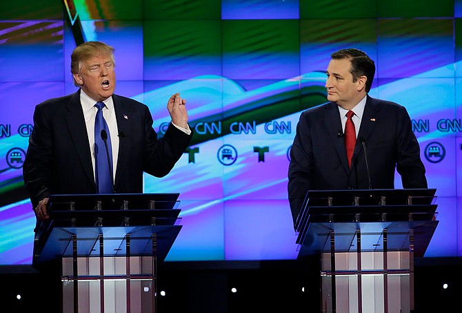 Sen. Ted Cruz, R-Texas listen as Donald Trump speaks during a February Republican presidential primary debate.