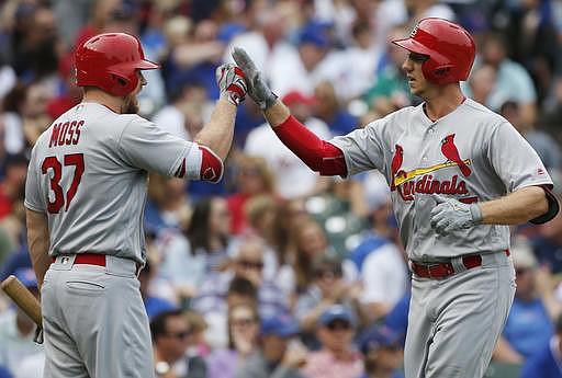 St. Louis Cardinals' Stephen Piscotty, right, celebrates with Brandon Moss after hitting a solo home run against the Chicago Cubs during the second inning of a baseball game Saturday, Sept. 24, 2016, in Chicago.